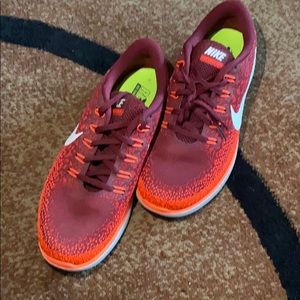 Brand new never worn Nike red running shoe.